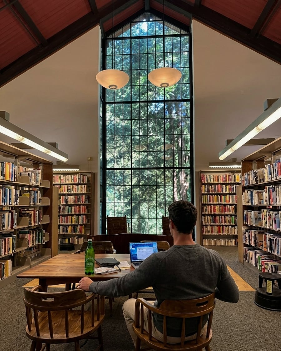 Kelan Bomar working on a laptop in a Marin library